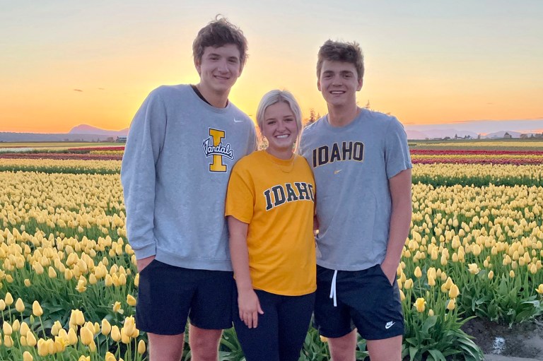 In this photo provided by Stacy Chapin, triplets Ethan (left), Maizie and Hunter Chapin pose in front of a tulip field in La Conner, Wash., in April of 2021. Ethan Chapin was one of four University of Idaho students found stabbed to death in a home near the Moscow, Idaho campus on Sunday, Nov. 13, 2022. 