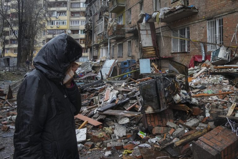 A woman cries in front of house damaged during Russian shelling in the town of Vyshgorod outside the capital Kiev, Ukraine, Thursday, Nov. 24, 2022. About 70% of the Ukrainian capital was left without power on Thursday morning after Moscow unleashed yet another devastating missile barrage on Ukraine's energy infrastructure, Kyiv's mayor said.