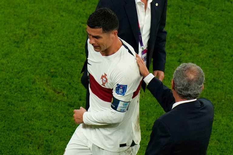 Portugal's Cristiano Ronaldo, left, reacts as he receives a pat from Portugal's head coach Fernando Santos after their loss in the World Cup quarterfinal soccer match against Morocco, at Al Thumama Stadium in Doha, Qatar, Saturday, Dec. 10, 2022.
