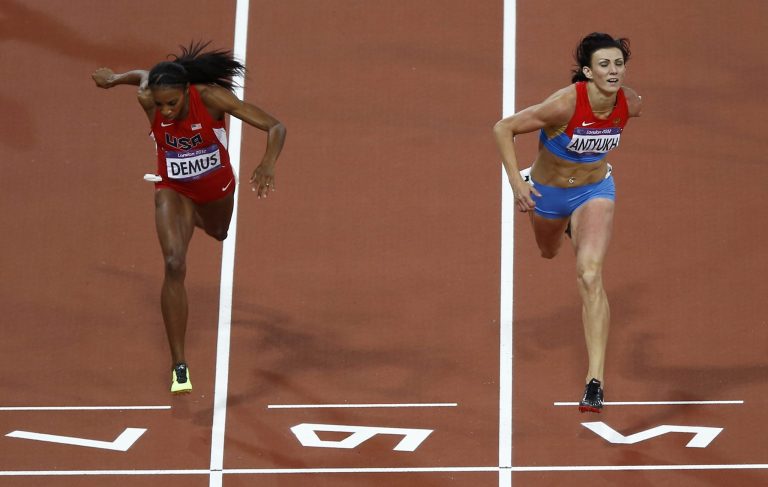 Russia's Natalya Antyukh, right, powers ahead of United States' Lashinda Demus to win gold in the women's 400-meter hurdles final during the athletics in the Olympic Stadium at the 2012 Summer Olympics in London, Wednesday, Aug. 8, 2012.