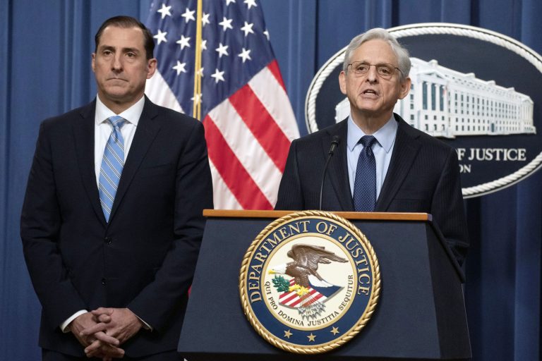 Attorney General Merrick Garland speaks during a news conference at the Department of Justice, Thursday, Jan. 12, 2023, in Washington, as John Lausch, the U.S. Attorney in Chicago, looks on.