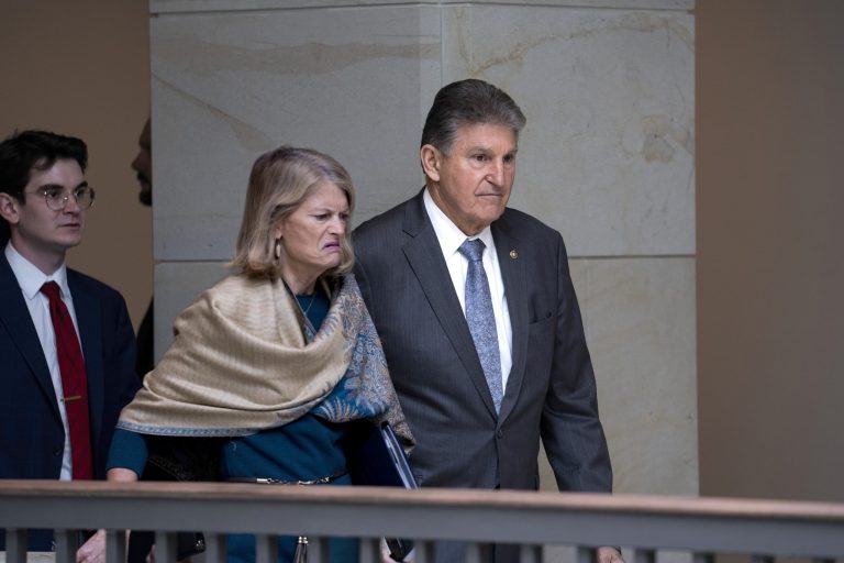 Sen. Lisa Murkowski and Sen. Joe Manchin head to a secure underground facility as lawmakers and intelligence advisers arrive for a closed briefing on the Chinese surveillance balloon that flew over the United States recently, at the Capitol in Washington, Thursday, Feb. 9, 2023.