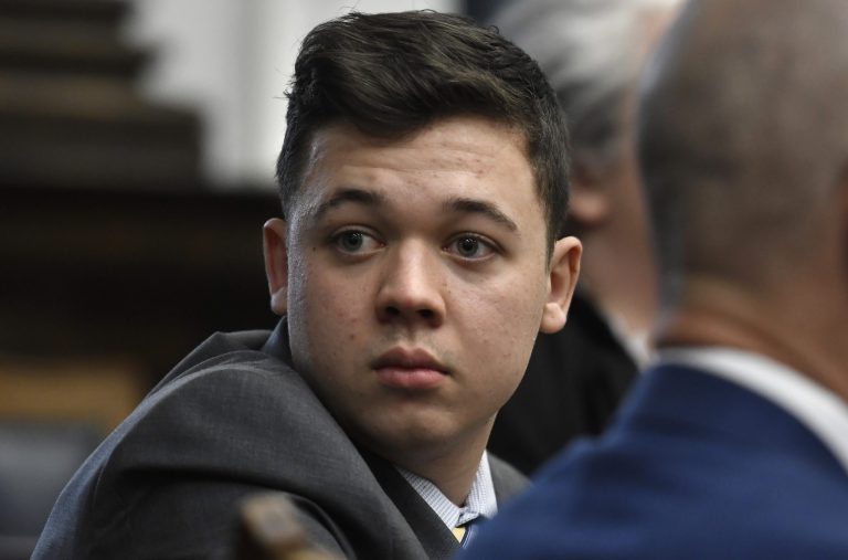 Kyle Rittenhouse looks back as attorneys discuss items in the motion for mistrial presented by his defense at the Kenosha County Courthouse in Kenosha, Wisconsin, on Wednesday, Nov. 17, 2021.