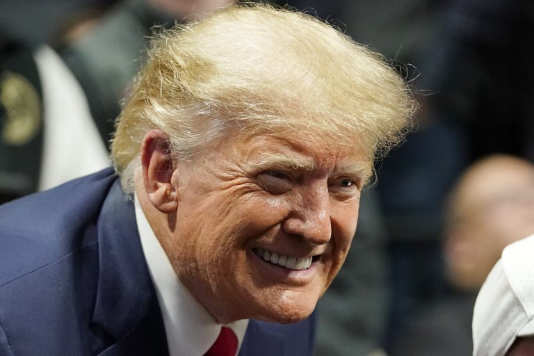 Former President Donald J. Trump smiles as he poses for a photo at the NCAA Wrestling Championships, Saturday, March 18, 2023, in Tulsa, Okla.