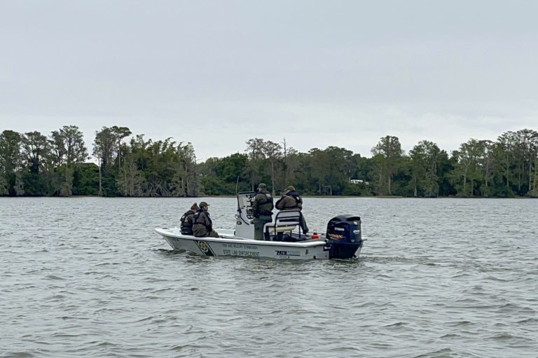This photo released by the Polk County Sheriff's Office shows authorities searching for two missing boaters in Lake Eloise.