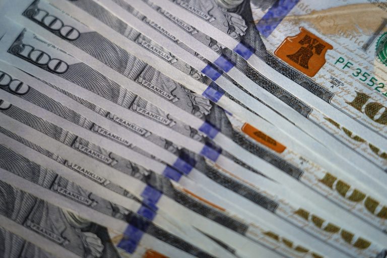 U.S. $100 bills are seen, Thursday, July 14, 2022, in Marple Township, Pennsylvania. (AP Photo/Matt Slocum)