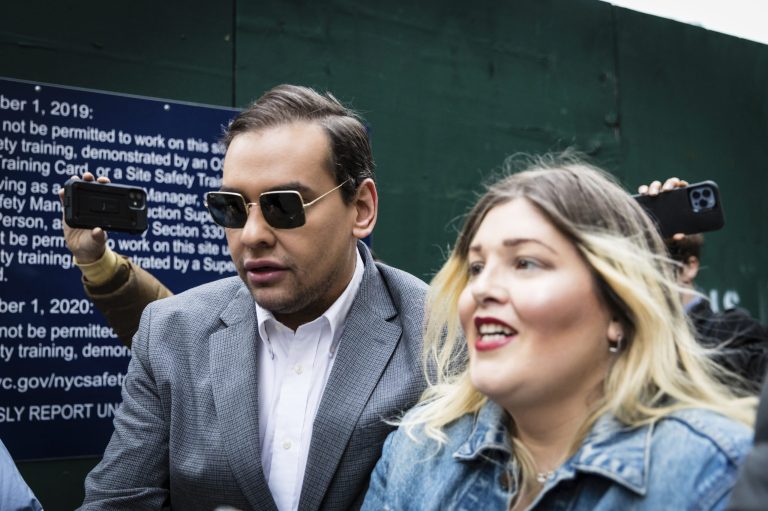 Rep. George Santos, R-N.Y., walks past the criminal courthouse in New York on Tuesday, April 4, 2023. 