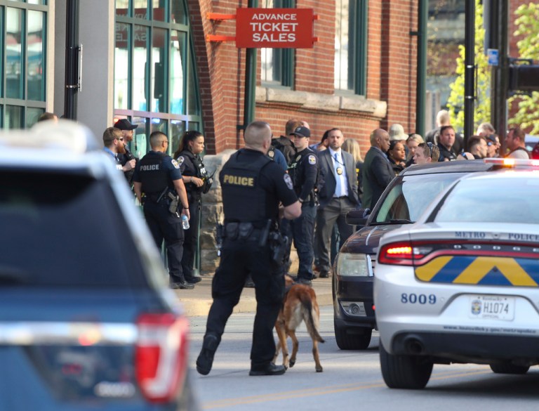 Multiple agencies arrive at a building after a shooting took place in Louisville, Ky., Monday, April 10, 2023. 