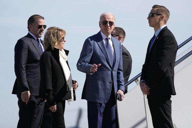 President Joe Biden gestures before he walked over to talk with reporters before boarding Air Force One, Tuesday, April 11, 2023, at Andrews Air Force Base, Md. With Biden are his son Hunter Biden, left, and sister Valerie Biden.