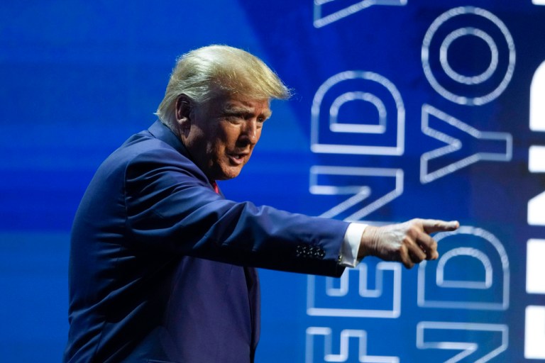Former President Donald Trump points to the crowd during at the National Rifle Association Convention in Indianapolis, Friday, April 14, 2023.