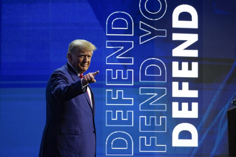 Former President Donald Trump points to the crowd during the National Rifle Association Convention in Indianapolis, Friday, April 14, 2023. 