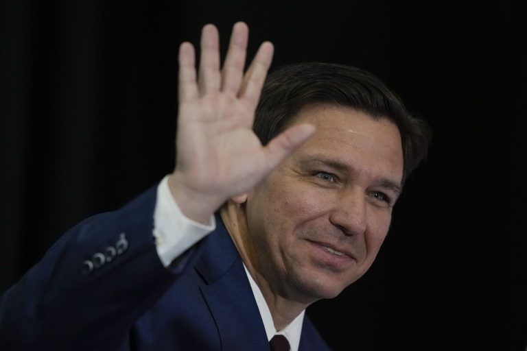 Florida Governor Ron DeSantis waves as he arrives for a press conference to sign several bills related to public education and teacher pay, in Miami, Tuesday, May 9, 2023. 