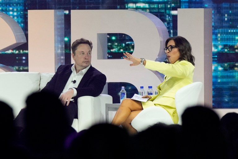Twitter CEO Elon Musk, center, speaks with Linda Yaccarino, chairman of global advertising and partnerships for NBC, at the POSSIBLE marketing conference, Tuesday, April 18, 2023, in Miami Beach, Fla. Musk announced Friday, May 12, 2023, that he's hiring Yaccarino to be the new CEO of San Francisco-based Twitter, which is now called X Corp. 