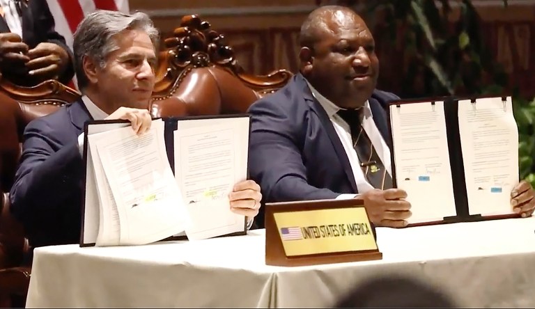 In this image made from video, U.S. Secretary of State Antony Blinken, left, and Papua New Guinea Prime Minister James Marape pose with documents after signing agreements in Port Moresby, Papua New Guinea Monday, May 22, 2023. The United States signed a new security pact with Papua New Guinea on Monday as it competes with China for influence in the Pacific. 