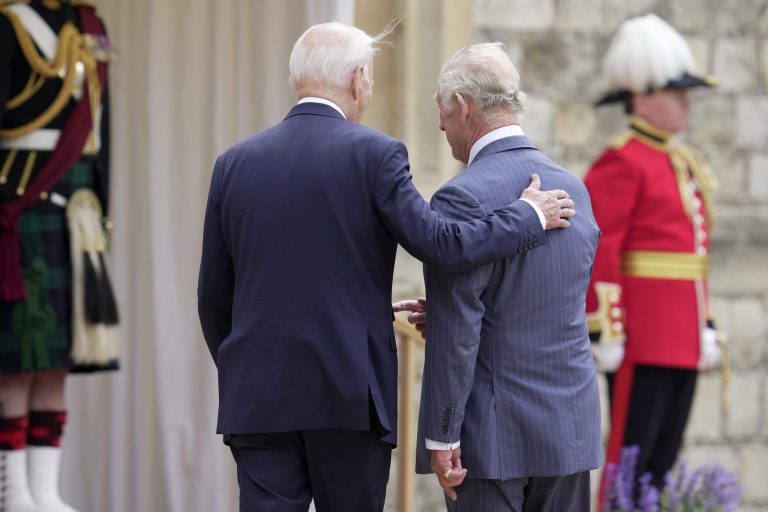 President Joe Biden walks with Britain's King Charles III during a ceremony before their meeting at Windsor Castle in Windsor, England, Monday, July 10, 2023.