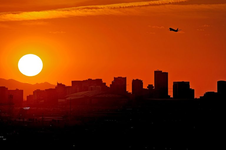 A Jet takes flight from Sky Harbor International Airport as the sun sets over downtown Phoenix, Wednesday, July 12, 2023.