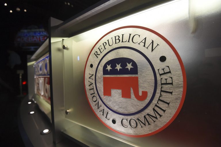 FILE - The Republican National Committee logo is shown on the stage as crew members work at the North Charleston Coliseum, Jan. 13, 2016, in North Charleston, S.C. With less than a month to go until the first 2024 Republican presidential debate, about half of the broad GOP field is running short on time to make the stage. (AP Photo/Rainier Ehrhardt, File)