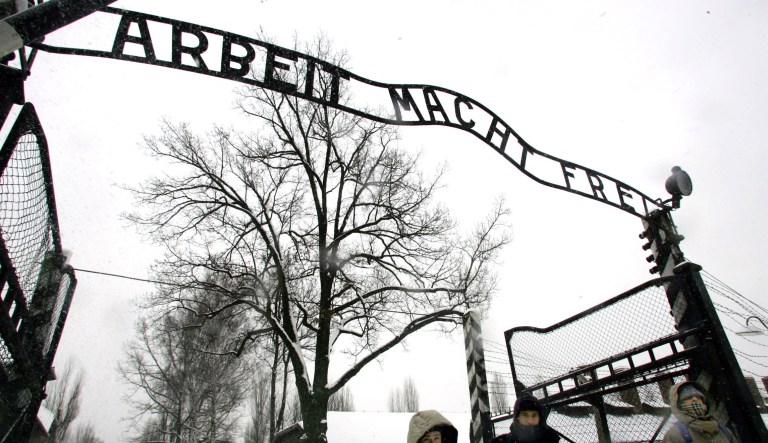  Visitors walk through the entrance gate of the Auschwitz Nazi concentration camp in Oswiecim, southern Poland on Wednesday, Jan. 26, 2005, a day before the commemorations of the 60th anniversary of the liberation of the Auschwitz Nazi concentration camp by Soviet troops will take place on Jan. 27, 2005. The writing reads: Work will set you free.