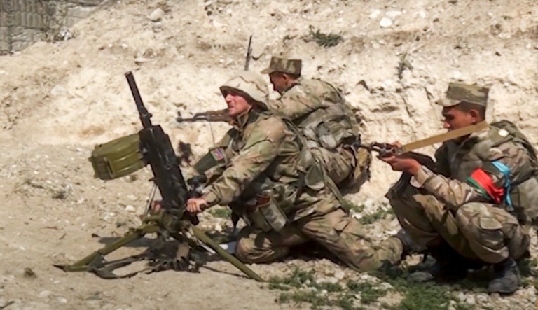 In this handout photo taken from a footage released by Azerbaijanâs Defense Ministry on Sunday, Sept. 27, 2020, Azerbaijanâs soldiers fire from a mortar at the contact line of the self-proclaimed Republic of Nagorno-Karabakh, Azerbaijan. Fighting between Armenian and Azerbaijani forces over the disputed separatist region of Nagorno-Karabakh continued on Monday morning after erupting the day before, with both sides blaming each other for resuming the attacks. 