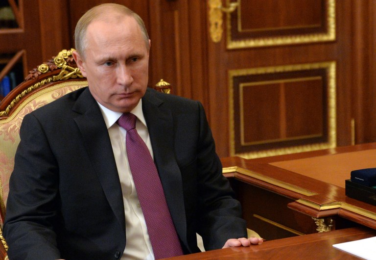 Russian President Vladimir Putin listens during a meeting in Moscow's Kremlin, Russia on Tuesday, Jan. 13, 2014. (AP Photo/RIA Novosti, Alexei Druzhinin, Presidential Press Service)