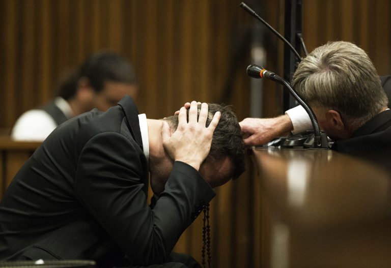 Oscar Pistorius, puts his hands to his head while listening to evidence from a witness speaking about the morning of the shooting of his girlfriend Reeva Steenkamp, in court on the fourth day of his trial at the high court in Pretoria, South Africa, Thursday, March 6, 2014.  Pistorius is charged with murder for the shooting death of his girlfriend,  Steenkamp, on Valentines Day in 2013. (AP Photo/Marco Longari, Pool)