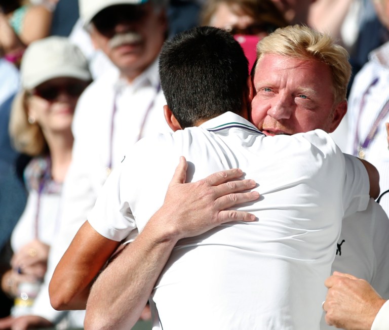 Novak Djokovic of Serbia celebrates with his coach Boris Becker, right, in the players box after defeating Roger Federer of Switzerland in the men's singles final at the All England Lawn Tennis Championships in Wimbledon, London, Sunday July 6, 2014. (AP Photo/Pavel Golovkin)