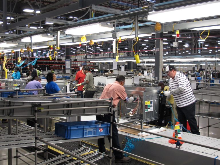 FILE - In this Thursday, Jan. 9, 2014, file photo, workers assemble ovens at the new Electrolux home cooking appliance factory in Memphis, Tenn.  The Federal Reserve releases industrial production for January on Friday, Feb. 14, 2014. (AP Photo/Adrian Sainz, File)