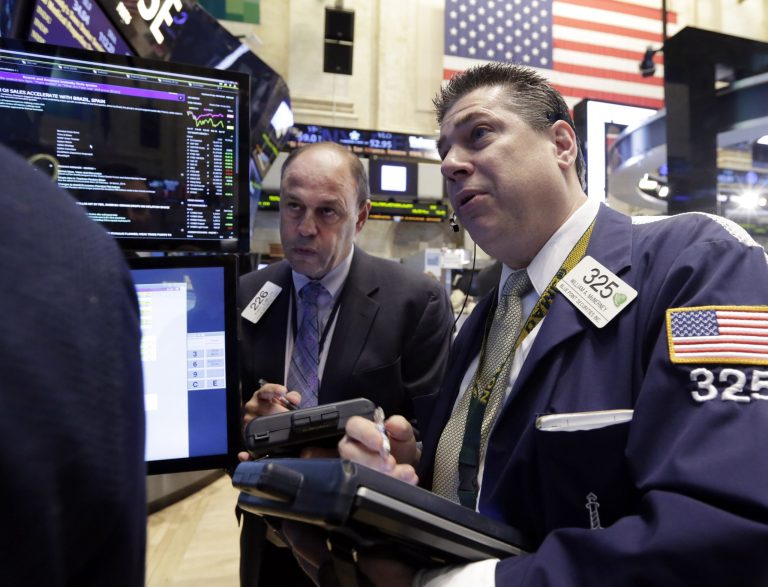 Traders Randy Beller, left, and William McInerney work on the floor of the New York Stock Exchange Thursday, April 10, 2014.  U.S. stock indexes are slipping lower in early trading Thursday as investors pick over a mixed batch of corporate earnings reports. (AP Photo/Richard Drew)