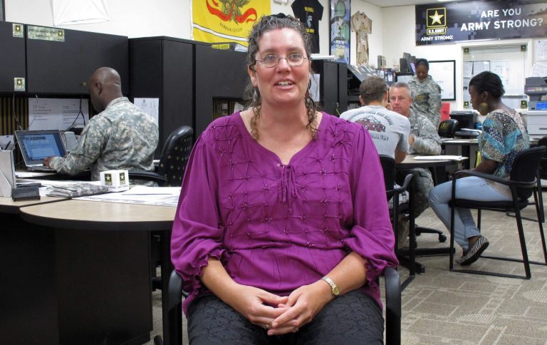   In this Oct. 17, 2012 photo, Leslie Ann Sully discusses her years in the active-duty Army, stationed in West Germany, during an interview in Columbia, S.C. Sully is a civilian who works with the U.S. Army Recruiting Battalion in South Carolina but volunteered to leave the active duty ranks during cutbacks in the 1990s. (AP Photo/Jeffrey Collins)  