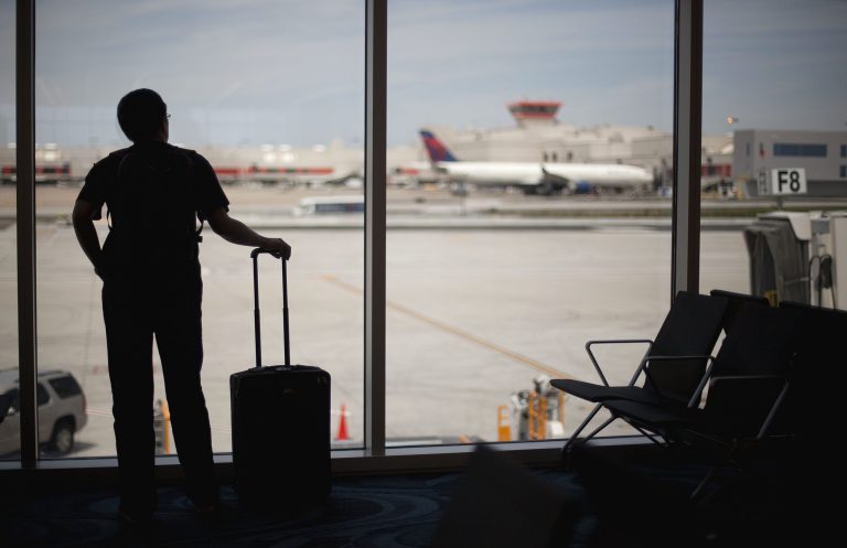   FILE- In this Wednesday, May 16, 2012, file photo, a passenger looks out from the Maynard Holbrook Jackson Jr. International Terminal at Atlanta's airport in Atlanta. There are some health care considerations vacationers can think about to prepare for summer vacation medical emergencies. (AP Photo/David Goldman, File)  