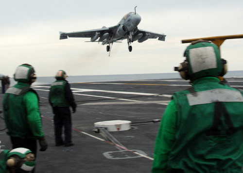 Sailors aboard the USS George H.W. Bush observe an EA-6B Prowler jet, assigned to Electronic Attack Squadron (VAQ) 209, land on the carrier in the Atlantic Ocean in 2010. (U.S. Navy photo by Mass Communication Specialist 3rd Class Brent Thacker)