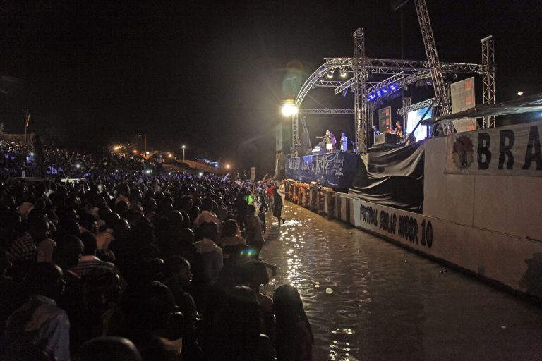 In this photo taken early Sunday, Feb. 9, 2014, Malian singer Salif Keita, rear center, performs on stage at a music festival at Segou, Mali.  Long before Mali captured the global spotlight as an al-Qaida training ground where French soldiers had to intervene, the West African nation was celebrated for producing some of the biggest stars in world music. (AP Photo/Baba Ahmed)