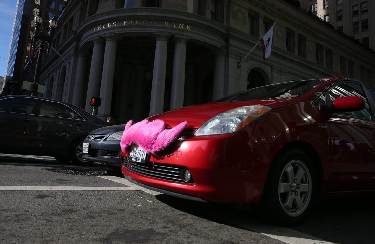 A Lyft car drives along Montgomery Street on January 21, 2014 in San Francisco, Calif. (Photo by Justin Sullivan/Getty Images)