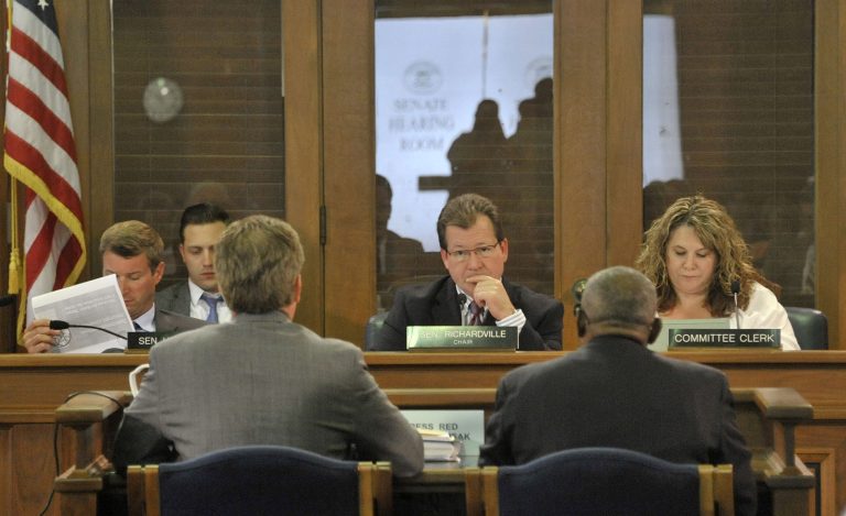 Under the leadership of Sen Randy Richardville, center, R-Monroe, the senate committee on Government Operations passed all the bills associated with easing Detroit's bankruptcy in Lansing, Mich., Tuesday, June 3, 2014. The Republican-led chamber voted 21-17 to contribute the state funds to join $466 million in commitments from 12 foundations and the Detroit Institute of Arts. The pool of money would shore up Detroit's two retirement systems while the city-owned art museum and its assets would be transferred to a private nonprofit. (AP Photo/Detroit News, Dale G. Young) DETROIT FREE PRESS OUT; HUFFINGTON POST OUT. MANDATORY CREDIT