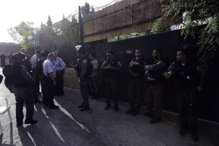 In this photo taken Tuesday, Sept. 30, 2014, Israeli police officers guard the house of Ziad Qarain, that Jewish settlers moved into, at the Palestinian neighborhood of Silwan, East Jerusalem. The settlers say the home has been legally purchased, while Palestinian residents claim such sales are fraudulent. (AP Photo/Mahmoud Illean)
