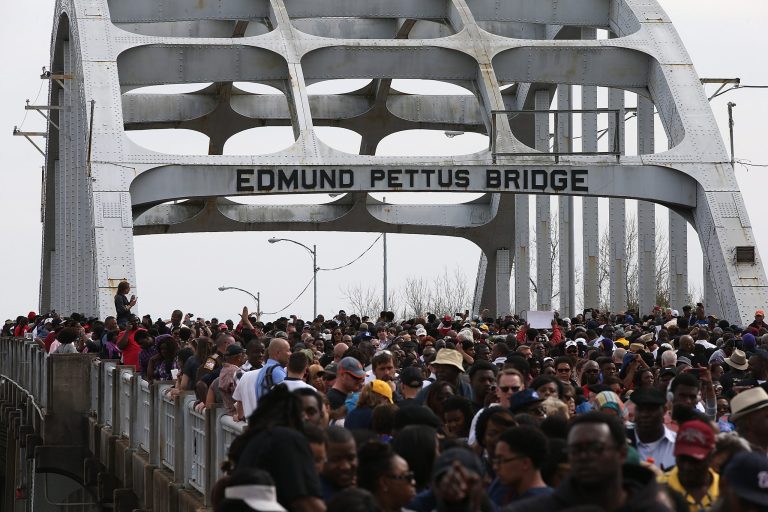 SELMA, AL - MARCH 08: Thousands of people walk across the Edmund Pettus Bridge during the 50th anniversary commemoration of the Selma to Montgomery civil rights march on March 8, 2015 in Selma, Alabama. Tens of thousands of people gathered in Selma to commemorate the 50th anniversary of the famed civil rights march from Selma to Montgomery that resulted in a violent confrontation with Selma police and State Troopers on the Edmund Pettus Bridge on March 7, 1965. (Photo by Justin Sullivan/Getty Images)