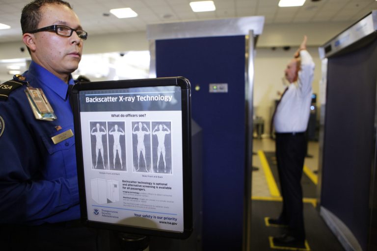 A Transportation Security Administration screener watches as a former TSA official goes through a full body X-ray scanner for a security screening in November 2010 at the Los Angeles International Airport. (AP Photo/Damian Dovarganes)