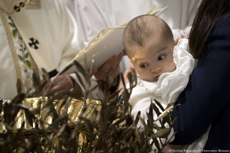 Pope Francis baptizes a baby inside the Sistine Chapel, at the Vatican, Sunday, Jan. 8, 2017. The pontiff baptized 28 babies. (L'Osservatore Romano/Pool Photo via AP)