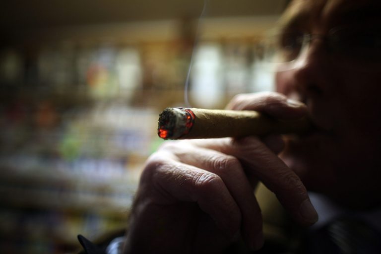 Cigar lover Paul Clarke samples a Havana cigar in Turmeau's, Liverpool's last remaining tobacconist shop on December 9, 2008, in Liverpool, England. (Photo by Christopher Furlong/Getty Images)