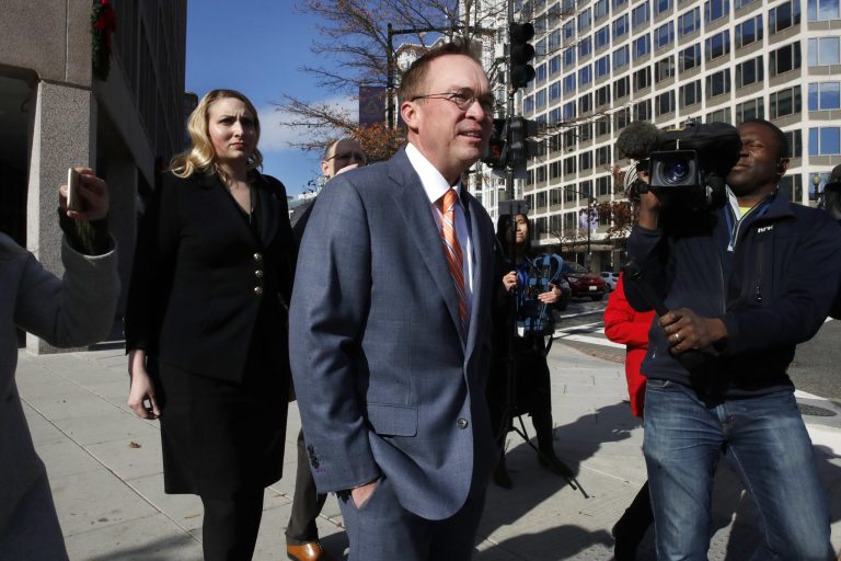Mick Mulvaney, center, leaves the Consumer Financial Protection Bureau in Washington, Monday, Nov. 27, 2017. (AP Photo/Jacquelyn Martin)