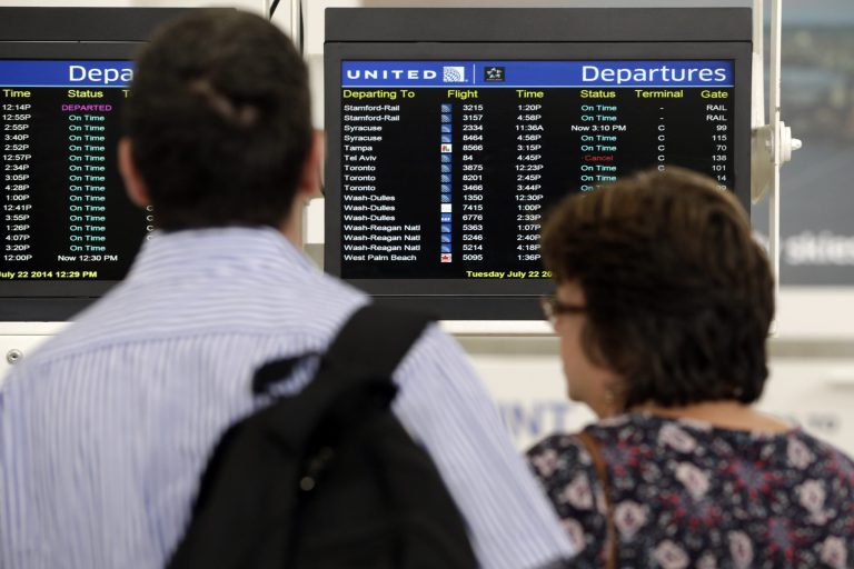 Travelers congregate in front of a departures board showing one canceled flight to Tel Aviv at Newark Liberty International Airport, Tuesday, July 22, 2014, in Newark, N.J. In a sign of increased caution about flying near combat zones, U.S. and European airlines halted flights to Israel Tuesday after a rocket landed near Tel Aviv's Ben Gurion Airport. Delta Air Lines and United Airlines suspended service between the U.S. and Israel indefinitely. The actions come days after a Malaysia Airlines jet was shot down over eastern Ukraine with 298 people on board. (AP Photo/Julio Cortez)