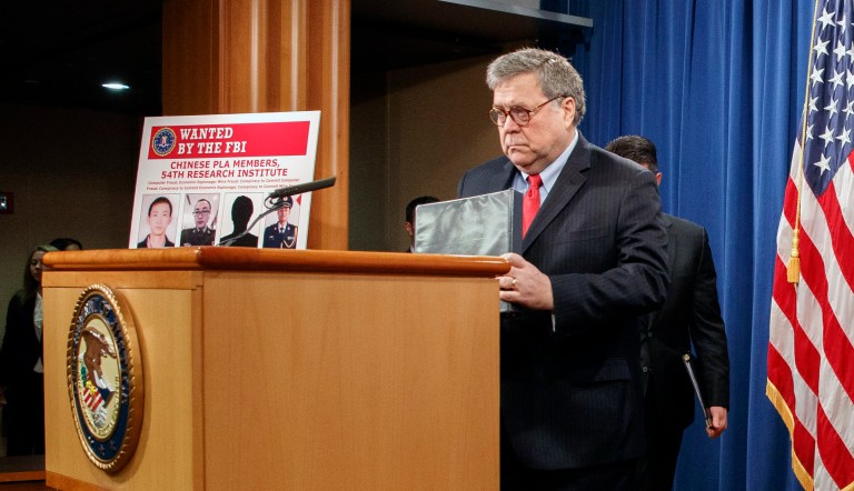Attorney General William Barr, left, arrives to  speak, next to Assistant Attorney General John Demers and U.S. Attorney for the Northern District of Georgia Byung "BJay" Pak, right, during a news conference about an indictment on hacking of four members of the Chinese military, Monday, Feb. 10, 2020, at the Justice Department in Washington. 