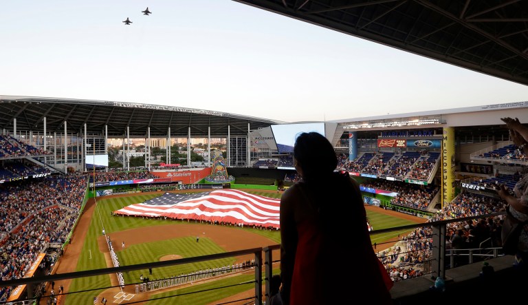 Two F-16s fly over Marlins Park during a ceremony before an interleague opening day baseball game between the Miami Marlins and the Detroit Tigers, Tuesday, April 5, 2016, in Miami.