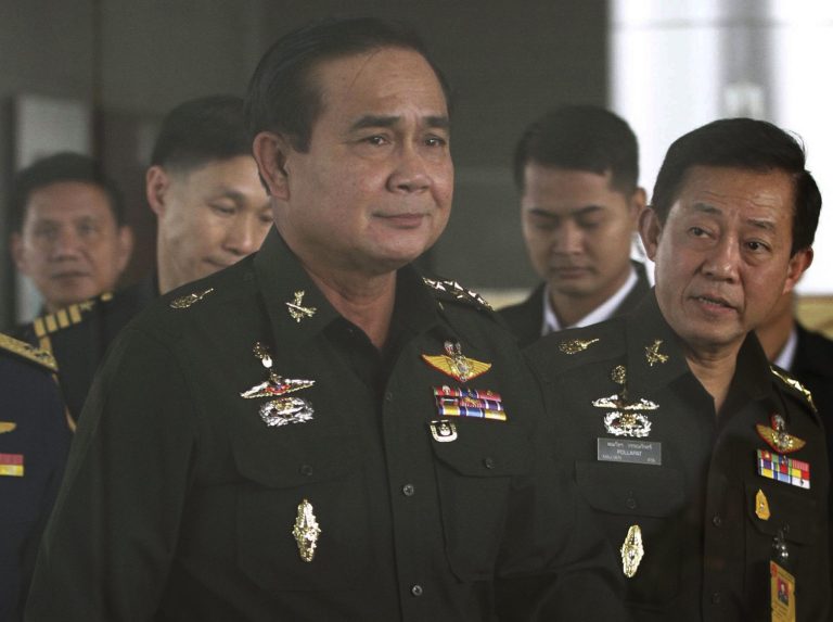 Thailand's Army commander Gen. Prayuth Chan-ocha, left, arrives at the Royal Thai Army Club in Bangkok, Thailand, Friday, June 13, 2014. The head of Thailand's military junta said Friday that an interim government would be set up by September, offering the most specific timeline yet on a possible transfer of power after last month's coup. (AP Photo/ASTV Manager newspaper) THAILAND OUT