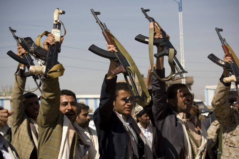 Houthi Shiite Yemeni raise their weapons during clashes near the presidential palace in Sanaa, Yemen, Monday, Jan. 19. (AP Photo/Hani Mohammed)