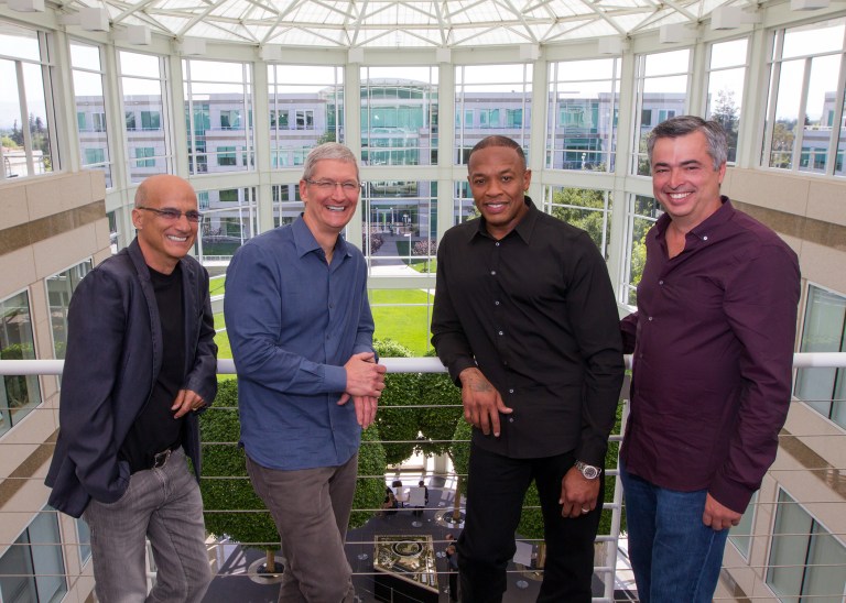 In this image provided by Apple, from left to right, music entrepreneur and Beats co-founder Jimmy Iovine, Apple CEO Tim Cook, Beats co-founder Dr. Dre, and Apple senior vice president Eddy Cue pose together at Apple headquarters in Cupertino, Calif., Wednesday, May 28, 2014. Apple is striking a new chord with a $3 billion acquisition of Beats Electronics, a headphone and music streaming specialist that also brings the swagger of rapper Dr. Dre and recording impresario Jimmy Iovine. The announcement on Wednesday comes nearly three weeks after deal negotiations were leaked to the media. (AP Photo/Apple, Paul Sakuma)