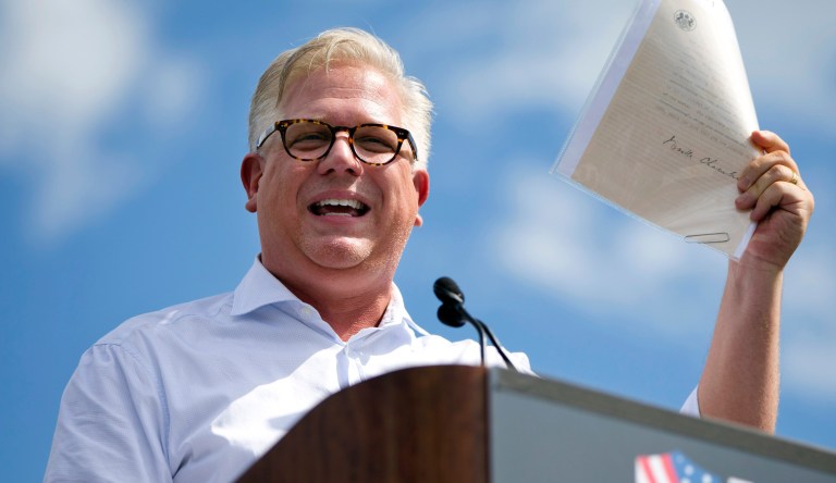 Glenn Beck holds up a document that he said was a WWII era Neville Chamberlain document during his speech during a Tea Party rally against the Iran deal on the West Lawn, of the Capitol in Washington, Wednesday Sept. 9, 2015. 