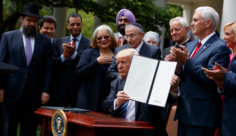 President Trump signed an executive order aimed at easing an IRS rule limiting political activity for churches. (AP Photo/Evan Vucci)