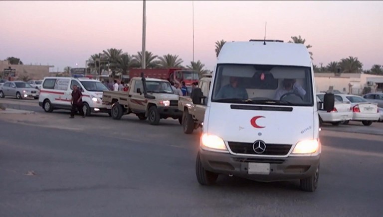 This image made from AP video shot on Wednesday, June 4, 2014 shows an ambulance carrying the body of a staff member of the International Committee of the Red Cross (ICRC), who was killed by armed men near the city of Sirte, which is around 550 kilometers (340 miles) east of Tripoli, Libya. ICRC Director-General Yves Daccord said in a statement on the organization's website Thursday, June 5, 2014 that Michael Greub, a 42-year-old Swiss national, was killed when the men attacked his car after he left a meeting.(AP Photo via AP video)