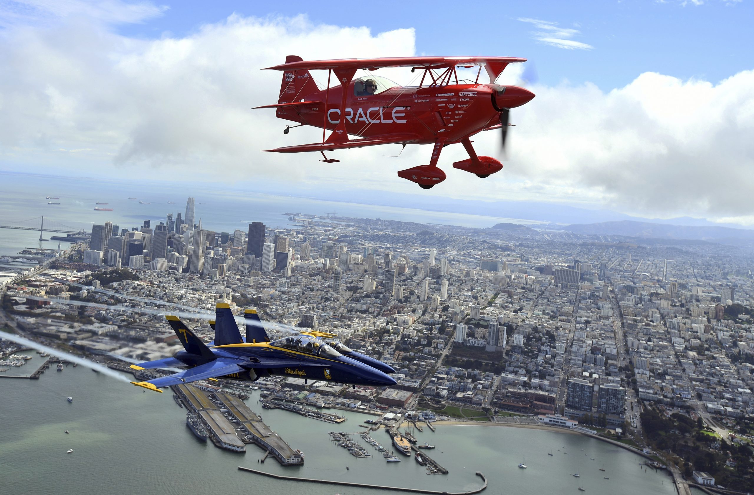 In advance of Fleet Week performances, Team Oracle aerobatics pilot Sean D. Tucker and the U.S. Navy Blue Angels fly over the San Francisco Bay on Thursday. 